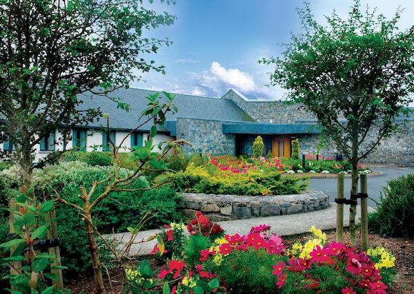 Exterior view of Knock House Hotel with gardens